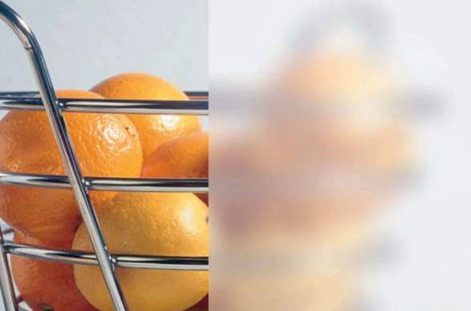 A metal basket full of oranges.