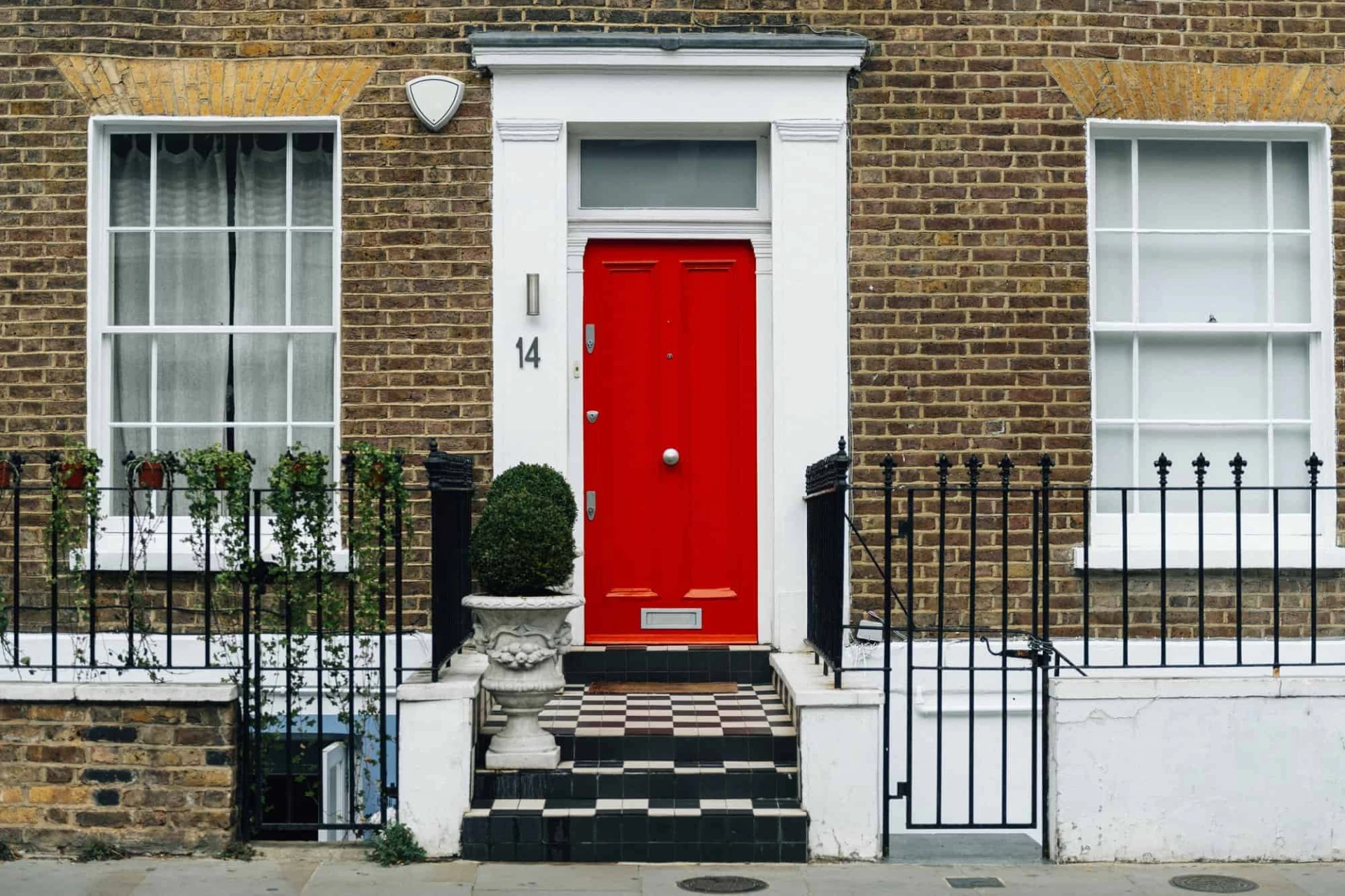 Red colored front door of a city house