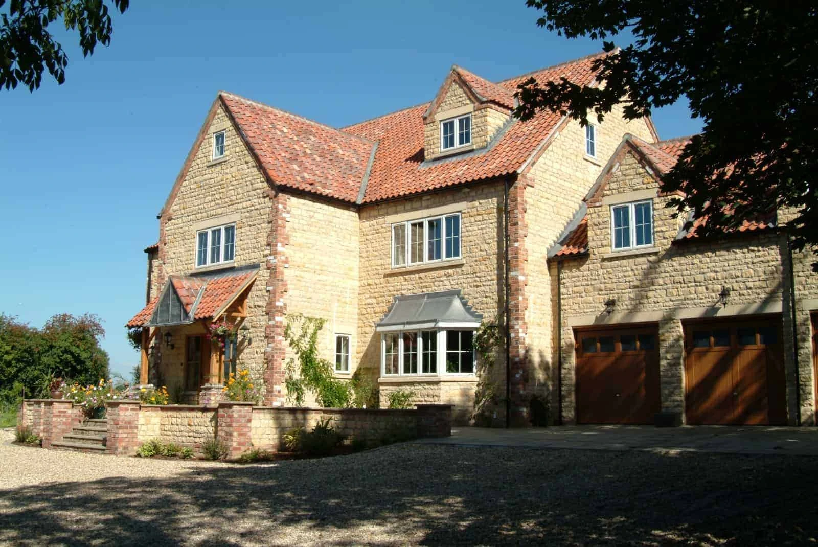 A spacious brick house with multiple windows.